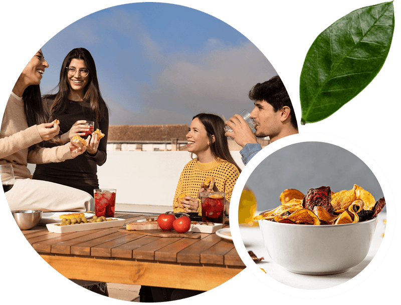 People enjoying a rooftop meal with a close-up of a bowl of snacks.